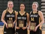 3 smiling women's basketball players holding awards